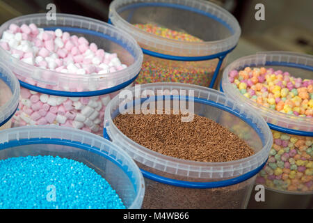 Several pots of colourful sugar ice cream toppings Stock Photo