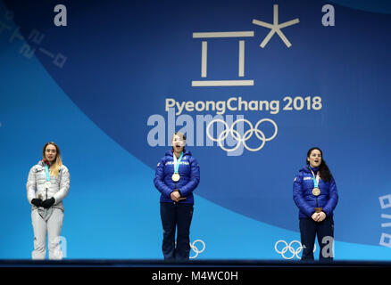 Great Britain's Lizzy Yarnold (centre) poses with her gold medal alongside Germay's Jacqueline Loelling (left) with her silver medal and Laura Deas with her bronze medal during the medal ceremony for the Women's Skeleton on day nine of the PyeongChang 2018 Winter Olympic Games in South Korea. Stock Photo