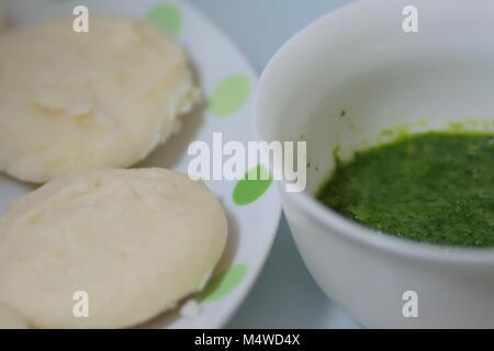 Food background of Indian famous street food Idli which is usually served with sauce made of coriander leaves Stock Photo
