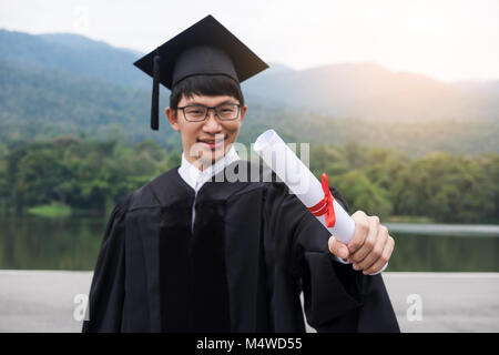 Graduation Student Commencement University Degree Concept, group of multiracial graduates holding diploma Celebration Education, Success Learning Conc Stock Photo