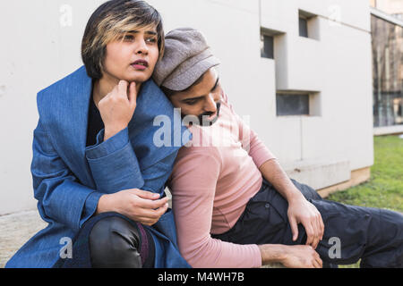 Beautiful Indian couple posing in an urban context. Street fashion and style. Stock Photo