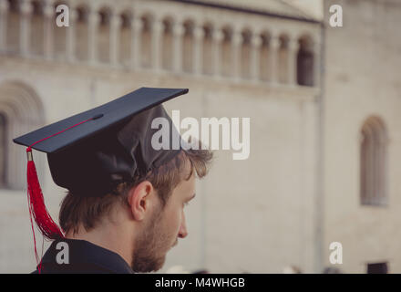 Portrait of a graduate during the graduation ceremony in the main square of the city of Trento. The city is famous for the prestigious universities. Stock Photo