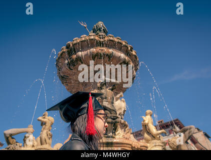 Portrait of a graduate during the graduation ceremony in the main square of the city of Trento. The city is famous for the prestigious universities. Stock Photo