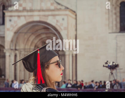 Portrait of a graduate during the graduation ceremony in the main square of the city of Trento. The city is famous for the prestigious universities. Stock Photo