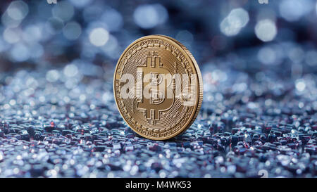 Gold coin bitcoin on a blue blurred background Stock Photo