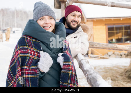 Portrait of modern young couple enjoying winter vacation together walking in nature at ski resort, copy space Stock Photo