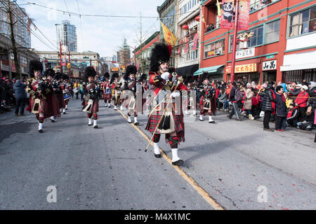 Vancouver, Canada. 18 February 2018. Vancouver Police Pipe Band performing.  Chinese Lunar New Year Parade Chinatown. Credit: GerryRousseau/Alamy Live News Stock Photo