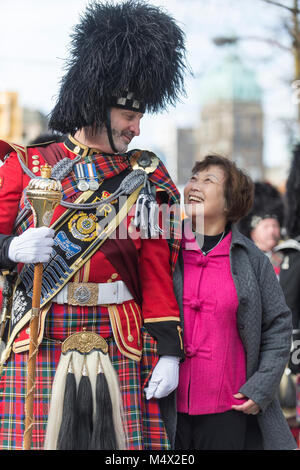 Vancouver, Canada. 18 February 2018. Vancouver Police Drum Major David Caven is met by a spectator for a photograph.  Chinese Lunar New Year Parade Chinatown. Credit: GerryRousseau/Alamy Live News Stock Photo