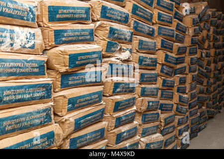 Paper bags with gypsum plastering machine application stand in the corridor Stock Photo