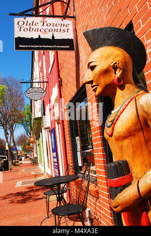 A controversial Cigar Store Indian stands outside a Tobacconist's store.  A native American statue has been the traditional indicator of the business Stock Photo