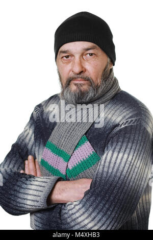Man with a beard in a hat and scarf looks at the camera on a white background Stock Photo