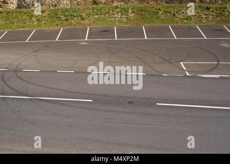 February 2018 - Tyre marks and skids left by young folk in the customised cars in the parking bays at the base of Cheddar Gorge. Stock Photo