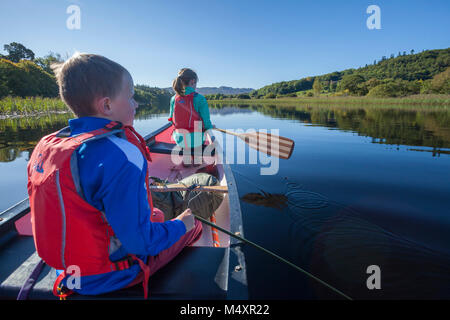 Family canoeing the Garavogue River to Lough Gill, Sligo town, County Sligo, Ireland. Stock Photo