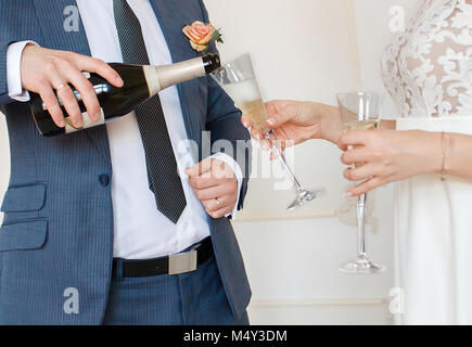 groom pouring the champagne to the bride closeup Stock Photo