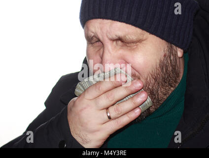 Bearded man coughs, covering his mouth with a handkerchief Stock Photo