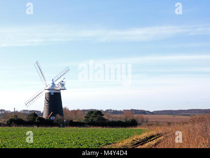 A view of Burnham Overy Staithe tower windmill in farmland by the A149 coast road in North Norfolk, England, United Kingdom, Europe. Stock Photo