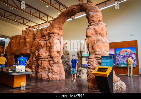Boy peers up at arch display inside the Visitor Center at Arches National Park. Stock Photo