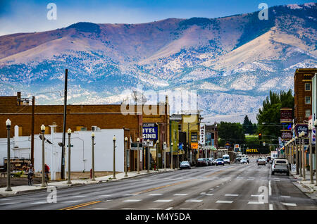 Route 50, the main street in western town of Ely, Nevada is seen against backdrop of mountain range.  Ely was founded as a stagecoach station along th Stock Photo