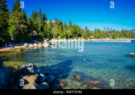 Beautiful swimming hole with clear natural lake water surrounded by boulders and pine trees at Lake Tahoe, Nevada. Stock Photo