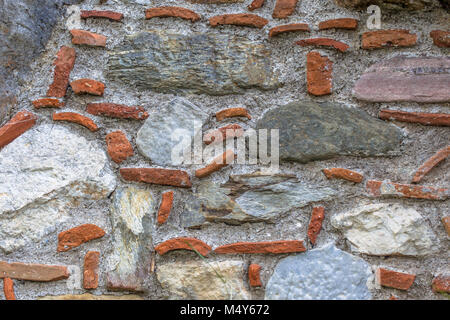 Stone wall background with natural stones and bricks Stock Photo