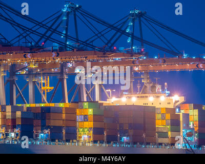 Detail of Container ship unloading at automated harbor terminal in Maasvlakte Europoort port of Rotterdam, Netherlands Stock Photo