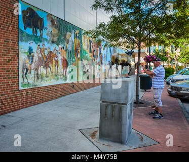 Visitor photographs New Beginnings mural in Sheridan, Wyoming. Stock Photo