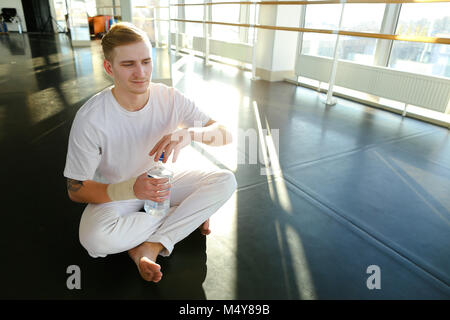Guy doing drinking water before morning training.  Stock Photo