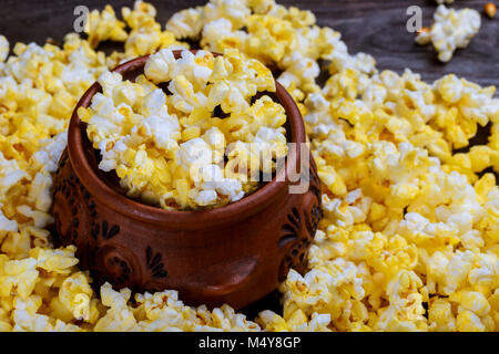 Popcorn popcorn on wood textured background closeup macro. Stock Photo