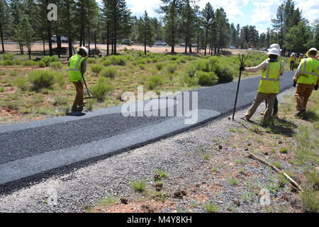 A paved section of the Greenway Trail.  Between August 10 to September 10, 2016 the Greenway Trail between the IMAX Theater parking area in Tusayan and Center Road in Grand Canyon National Park will be closed while Grand Canyon's trail crew installs asphalt. The portion of the trail north of Center Road will not be affected.  While the trail closure is in effect, cyclists and hikers may ride the Tusayan shuttle (Purple Route) which is equipped with bicycle carrier racks. The shuttle connects Tusayan with the South Rim Visitor Center, a 20 minute ride each way.  The intent of this project is to Stock Photo