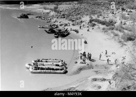 NEVILLS' 5TH COLORADO RIVER EXPEDITION UNLOADS AT CAMPSITE AT MOUTH OF BRIGHT ANGEL CREEK.  FRESH SUPPLIES WERE SECURED AND PARTY LEFT FOR LAKE MEAD.  PHOTOGRAPHER J.M. EDEN.  CIRCA 1947.    Grand Canyon Nat Park Historic River Photo. Stock Photo