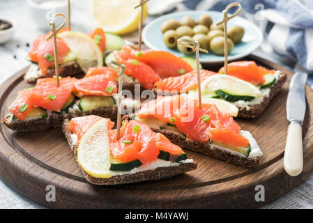 Canape sandwiches with salmon, cucumber and cream cheese. Closeup view Stock Photo