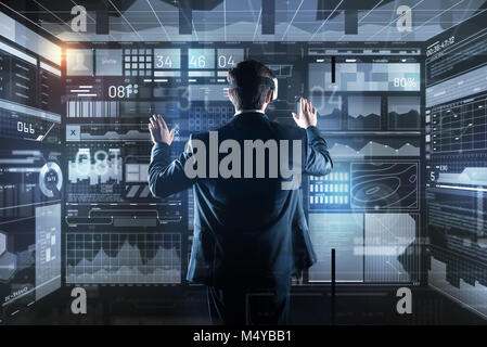 Calm programmer wearing virtual reality glasses while working Stock Photo