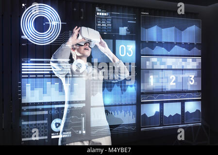 Emotional woman feeling surprised while exploring virtual reality Stock Photo
