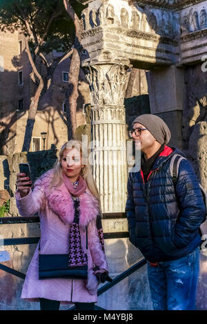 Young caucasian couple taking selfie at the remains of Imperial Roman forum, Trajan's Market, Trajan’s forum. Rome, Latium, Italy, Europe. Close up. Stock Photo