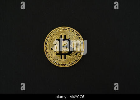 Single conceptual physical gold Bitcoin isolated on black background with copy space Stock Photo