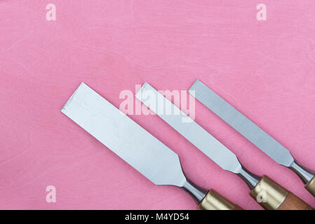 professional chisels on a pink background Stock Photo