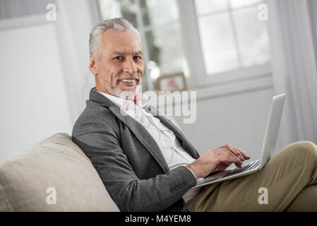 Cheerful bearded man posing on camera Stock Photo