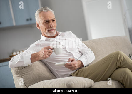 Thoughtful bearded man drinking coffee Stock Photo