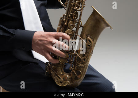 Hands of saxophone player Stock Photo