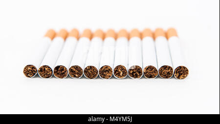 Stack of cigarette on the white background with partial focus Stock Photo