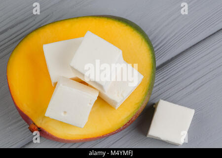 cubes of marshmelow on a gray background, next to avocado Stock Photo