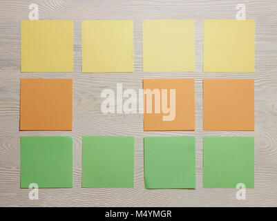 Stationary, Blank Colored Sticker Notes on White Wooden Board. Top View. Flat Lay. Time-management, Planning. Stock Photo