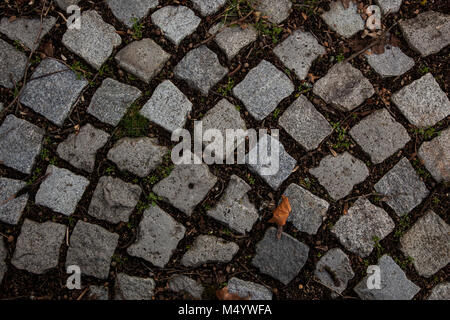 Stone pavement texture. Granite cobble stoned pavement background. Abstract background of old cobblestone pavement close-up. Seamless texture. Prague Stock Photo