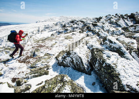 Side view of woman hiking in winter in White Mountains, New Hampshire, USA Stock Photo