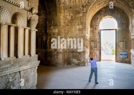 Man looking up taking photo with his cell phone in Umayyad Palace, Amman Citadel, Amman, Jordan Stock Photo