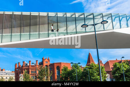 A modern glass bridge that leads to John Lewis department store in Liverpool One shopping centre, Uk. Stock Photo