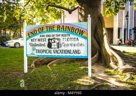 End of the Rainbow sign next to Kapok tree and end of U.S. Route 1. US 1 travels along the east coast of Florida, beginning in Key West running 2,369  Stock Photo