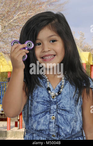 Girl with fidget spinner Stock Photo