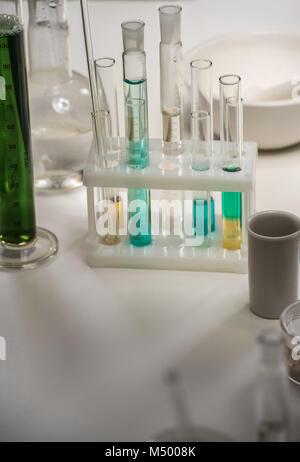 Group of laboratory flasks with liquid on table Stock Photo