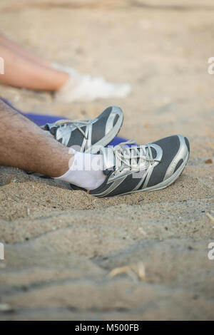 Portrait of unrecognizable couple resting after running outdoors Stock Photo